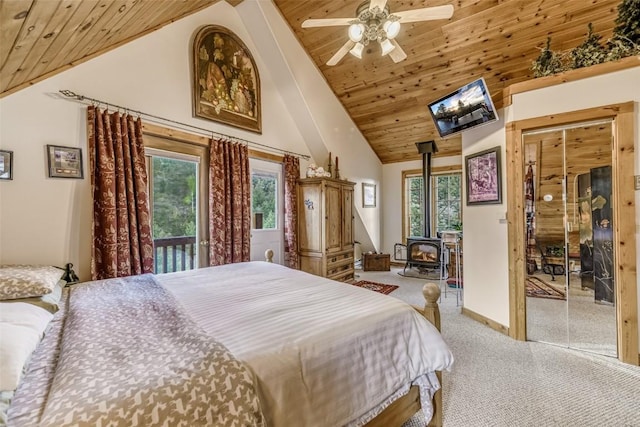 664 Tonkawa Rd, Hartsel, CO 80449 - bedroom featuring wooden ceiling, carpet flooring, a wood stove, multiple windows, and access to exterior
