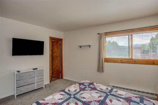 bedroom with light colored carpet and a baseboard heating unit