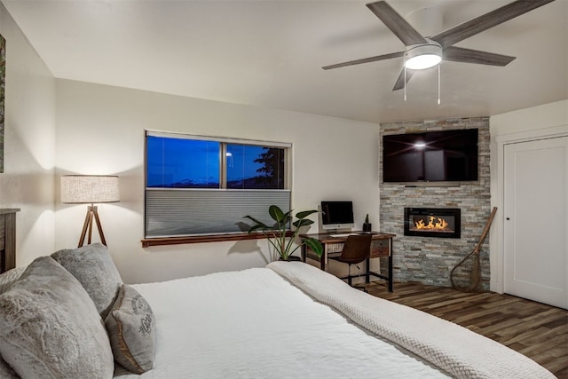 7 Lookout Ridge Dr Unit 7, Dillon, CO 80435 - bedroom featuring wood finished floors, a stone fireplace, and ceiling fan