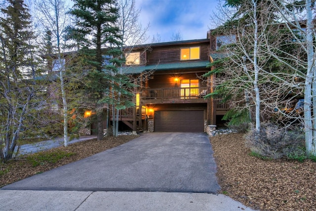 7 Lookout Ridge Dr Unit 7, Dillon, CO 80435 - rustic home featuring asphalt driveway, a garage, and stone siding