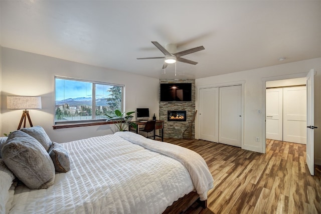 7 Lookout Ridge Dr Unit 7, Dillon, CO 80435 - bedroom with wood finished floors, a fireplace, a closet, and ceiling fan