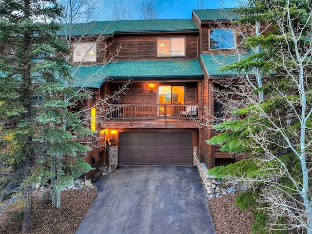 7 Lookout Ridge Dr Unit 7, Dillon, CO 80435 - rustic home with an attached garage, roof with shingles, and asphalt driveway