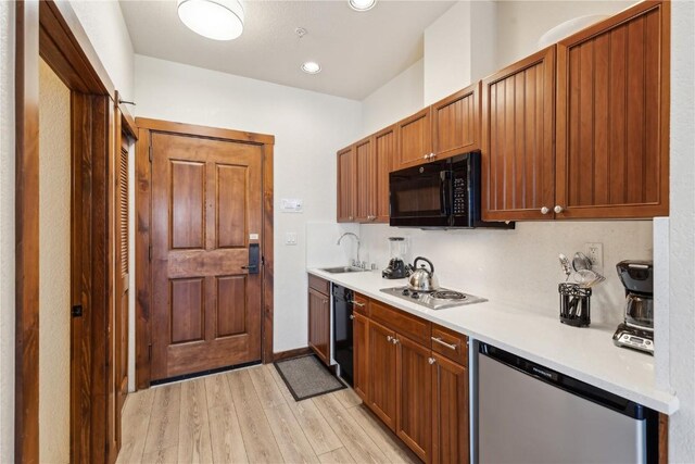 505A S Main St Unit 1204, Breckenridge, CO 80424 - kitchen featuring black microwave, dishwashing machine, light countertops, a sink, and light wood-style flooring