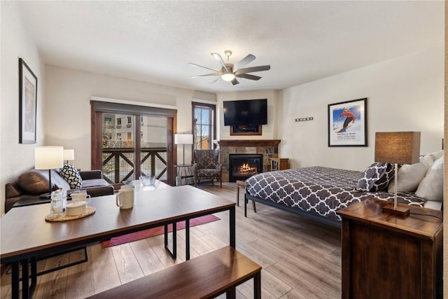 505A S Main St Unit 1204, Breckenridge, CO 80424 - bedroom featuring light wood-type flooring and a warm lit fireplace