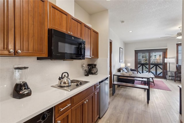 505A S Main St Unit 1204, Breckenridge, CO 80424 - kitchen featuring a ceiling fan, brown cabinets, light countertops, stainless steel appliances, and light wood-style flooring