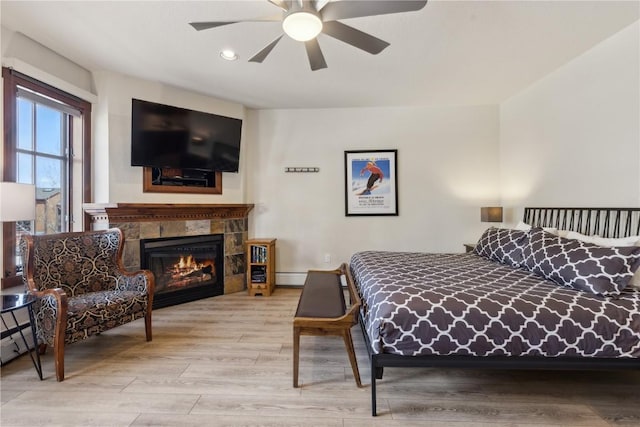 505A S Main St Unit 1204, Breckenridge, CO 80424 - bedroom featuring a ceiling fan, wood finished floors, a fireplace, recessed lighting, and a baseboard radiator