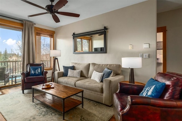 1463 Flattop Cir Unit 204, Steamboat Springs, CO 80487 - living area with wood finished floors, a ceiling fan, and a baseboard heating unit