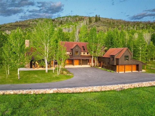33225 Painted Pony Ln, Steamboat Springs, CO 80487 - view of front of home with a view of trees and a front lawn
