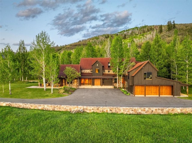 33225 Painted Pony Ln, Steamboat Springs, CO 80487 - view of front of house with a front lawn, a forest view, and a mountain view