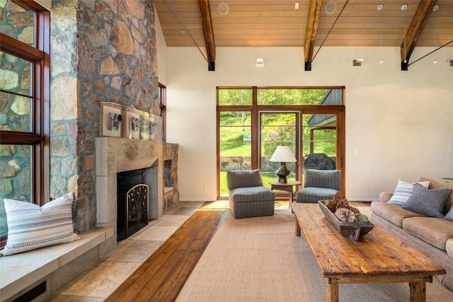 33225 Painted Pony Ln, Steamboat Springs, CO 80487 - living room with a wooden ceiling with exposed beams, a stone fireplace, and high vaulted ceiling