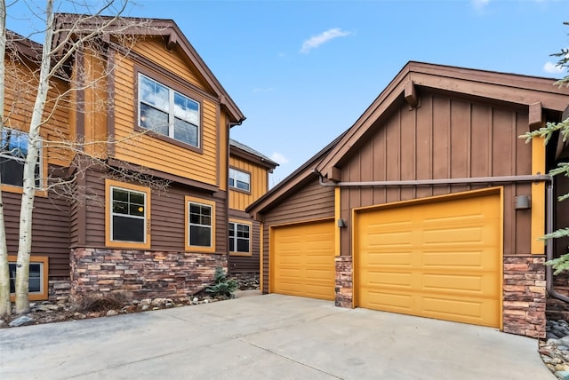200 Rachel Ln, Breckenridge, CO 80424 - view of front of property featuring stone siding, board and batten siding, concrete driveway, and an attached garage