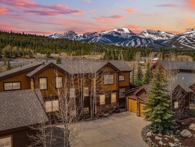 200 Rachel Ln, Breckenridge, CO 80424 - view of front of home featuring a mountain view, driveway, board and batten siding, and an attached garage