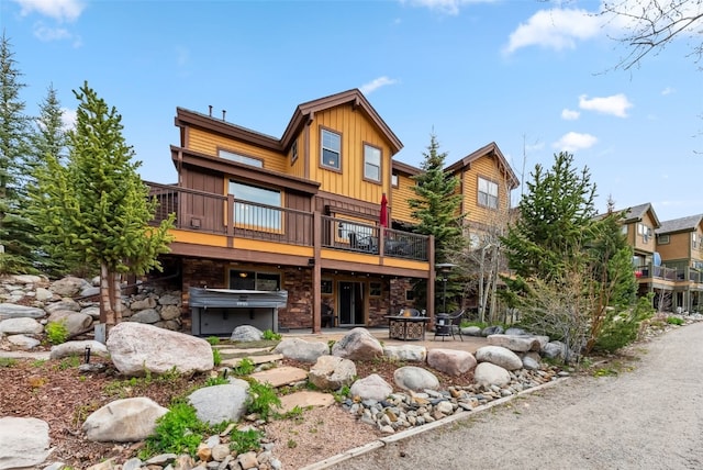 200 Rachel Ln, Breckenridge, CO 80424 - back of property with board and batten siding, a patio, a deck, and stone siding