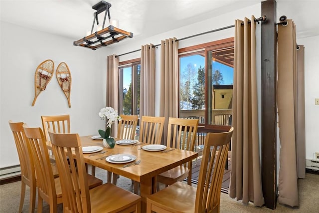 dining space featuring a baseboard heating unit and carpet floors
