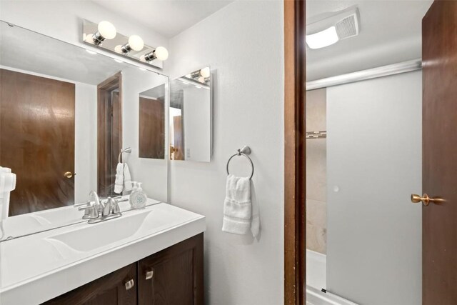 bathroom featuring vanity and a stall shower