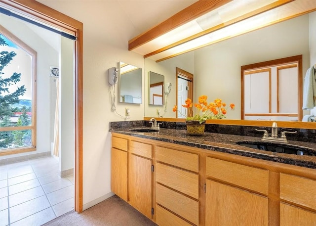 bathroom with a sink, tile patterned flooring, and double vanity