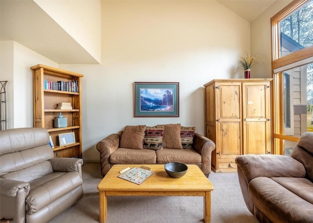 living room featuring high vaulted ceiling and light carpet