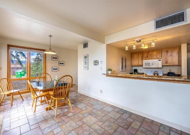 dining room with visible vents and baseboards