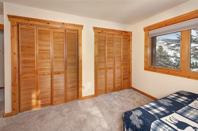 324 Black Hawk Cir, Silverthorne, CO 80498 - carpeted bedroom with baseboards and multiple closets