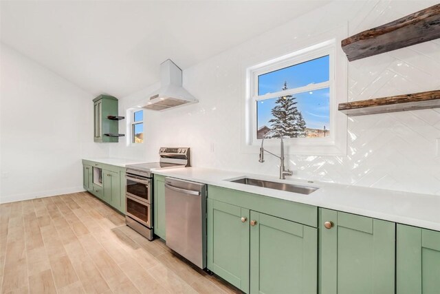 32655 County Road 179, Oak Creek, CO 80467 - kitchen featuring stainless steel appliances, green cabinetry, open shelves, wall chimney range hood, and recessed lighting
