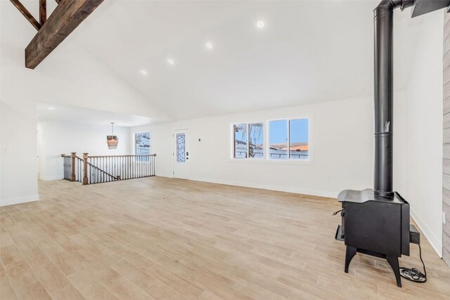 32655 County Road 179, Oak Creek, CO 80467 - unfurnished living room featuring a wood stove, high vaulted ceiling, beam ceiling, light wood-style floors, and recessed lighting