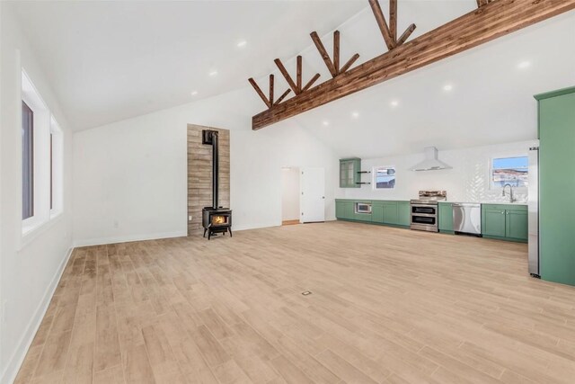 32655 County Road 179, Oak Creek, CO 80467 - unfurnished living room featuring a wood stove, high vaulted ceiling, beam ceiling, light wood-style floors, and recessed lighting