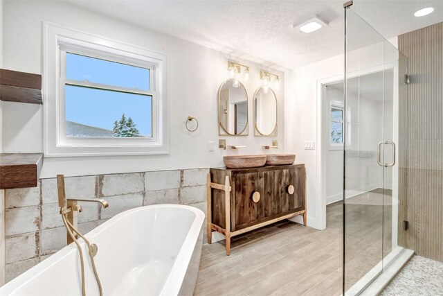 32655 County Road 179, Oak Creek, CO 80467 - bathroom with tile walls, vanity, a freestanding bath, a shower stall, and a wainscoted wall