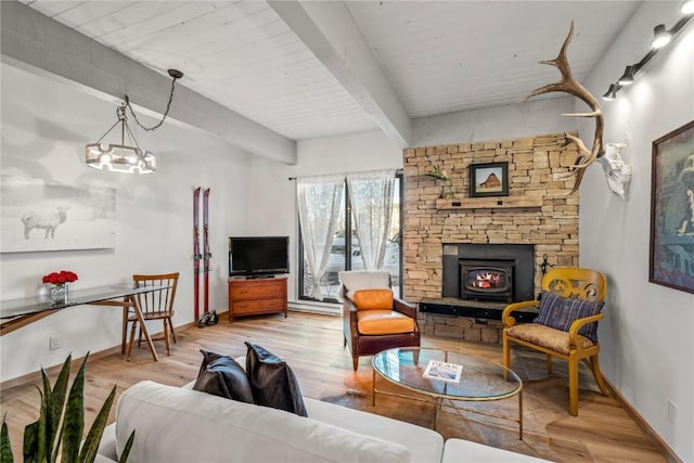 living room with baseboards, wood finished floors, and beamed ceiling