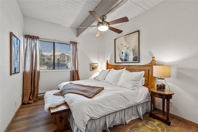 bedroom with baseboards, vaulted ceiling with beams, and wood finished floors