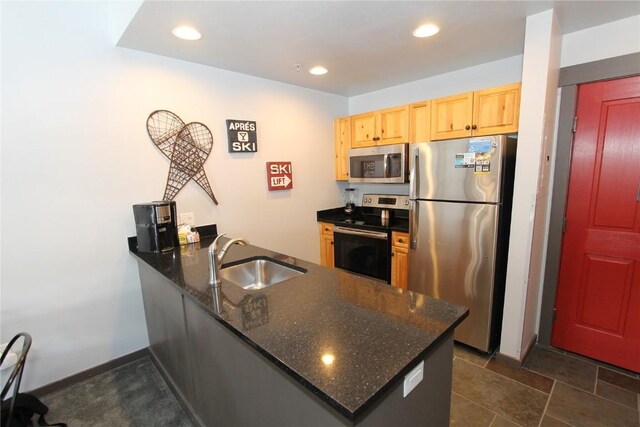 172 Copper Cir Unit 101, Copper Mountain, CO 80443 - kitchen with light brown cabinets, a sink, a peninsula, appliances with stainless steel finishes, and recessed lighting