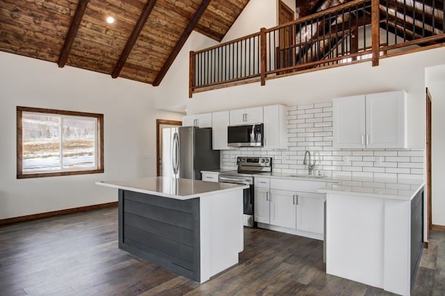 kitchen featuring a sink, dark wood-style flooring, baseboards, wood ceiling, and appliances with stainless steel finishes