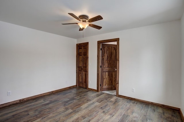 unfurnished bedroom featuring wood finished floors, a closet, a ceiling fan, and baseboards