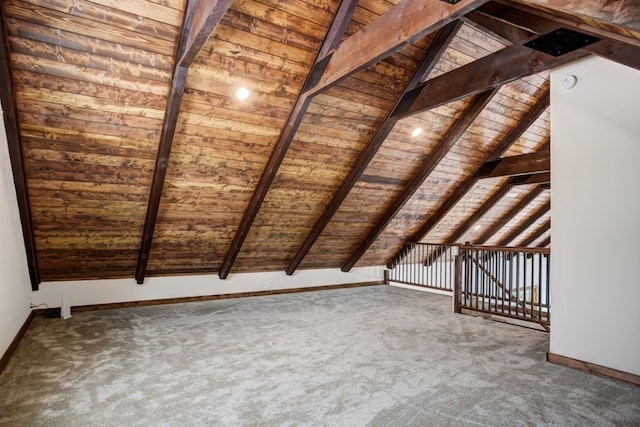 interior space with baseboards, carpet floors, wooden ceiling, and lofted ceiling with beams