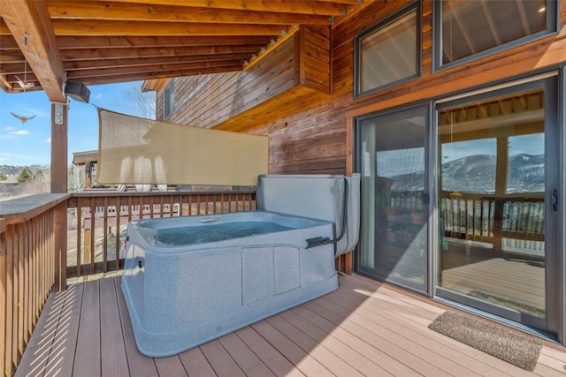 wooden deck featuring a hot tub