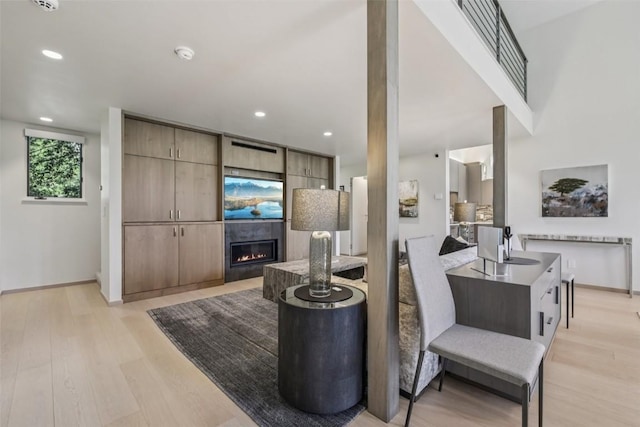 405 Creekside Dr, Frisco, CO 80443 - living room featuring light wood finished floors, a glass covered fireplace, and recessed lighting