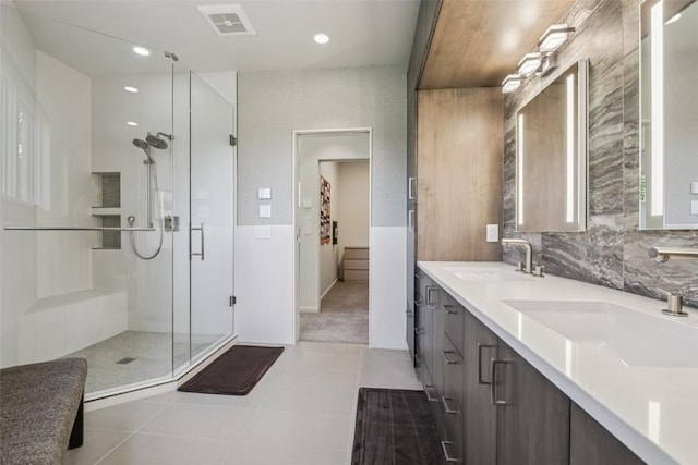 405 Creekside Dr, Frisco, CO 80443 - bathroom with a stall shower, double vanity, tile patterned flooring, tasteful backsplash, and recessed lighting
