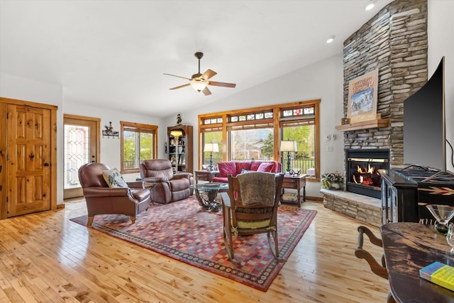 1088 Longview Cir Unit 1, Steamboat Springs, CO 80487 - living room with wood-type flooring, a ceiling fan, lofted ceiling, a stone fireplace, and recessed lighting
