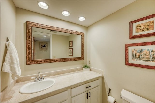 bathroom featuring toilet and vanity