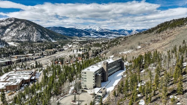 snowy aerial view featuring a mountain view