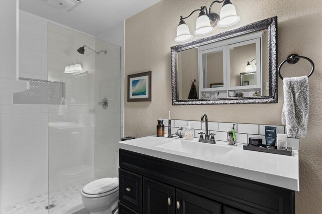 2146 Aster Pl Unit 3, Steamboat Springs, CO 80487 - full bathroom with a textured wall, toilet, a tile shower, and vanity