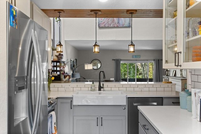 2146 Aster Pl Unit 3, Steamboat Springs, CO 80487 - kitchen with stainless steel appliances, a sink, light countertops, glass insert cabinets, and pendant lighting