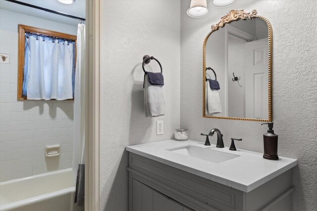 2146 Aster Pl Unit 3, Steamboat Springs, CO 80487 - bathroom featuring vanity, a textured wall, and shower / bath combo with shower curtain