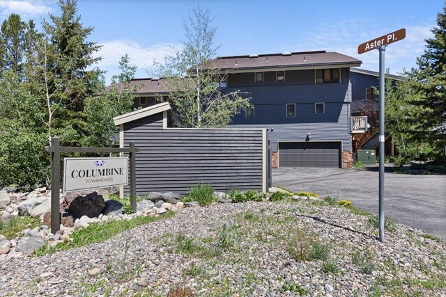 2146 Aster Pl Unit 3, Steamboat Springs, CO 80487 - view of front facade featuring an attached garage and asphalt driveway