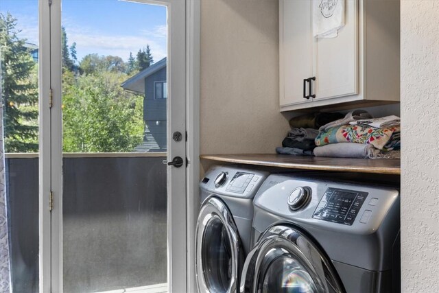 2146 Aster Pl Unit 3, Steamboat Springs, CO 80487 - laundry area featuring cabinet space, washing machine and dryer, and a textured wall