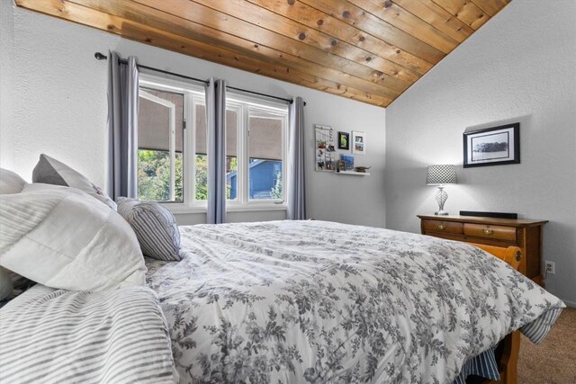 2146 Aster Pl Unit 3, Steamboat Springs, CO 80487 - carpeted bedroom featuring vaulted ceiling, wooden ceiling, and a textured wall
