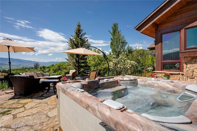 35525 Humble Rd, Steamboat Springs, CO 80487 - view of patio featuring a hot tub, an outdoor hangout area, and a mountain view