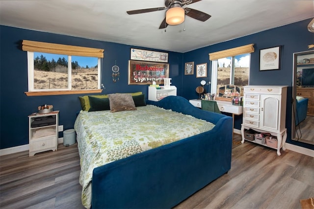 bedroom with baseboards, wood finished floors, and ceiling fan