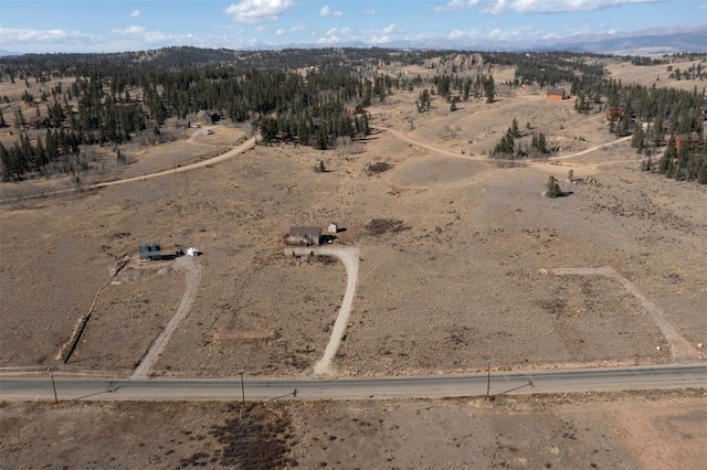 drone / aerial view featuring a rural view and view of desert
