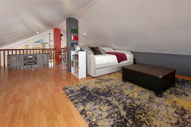 bedroom featuring lofted ceiling and wood finished floors