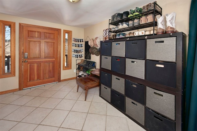 foyer entrance with baseboards and light tile patterned floors